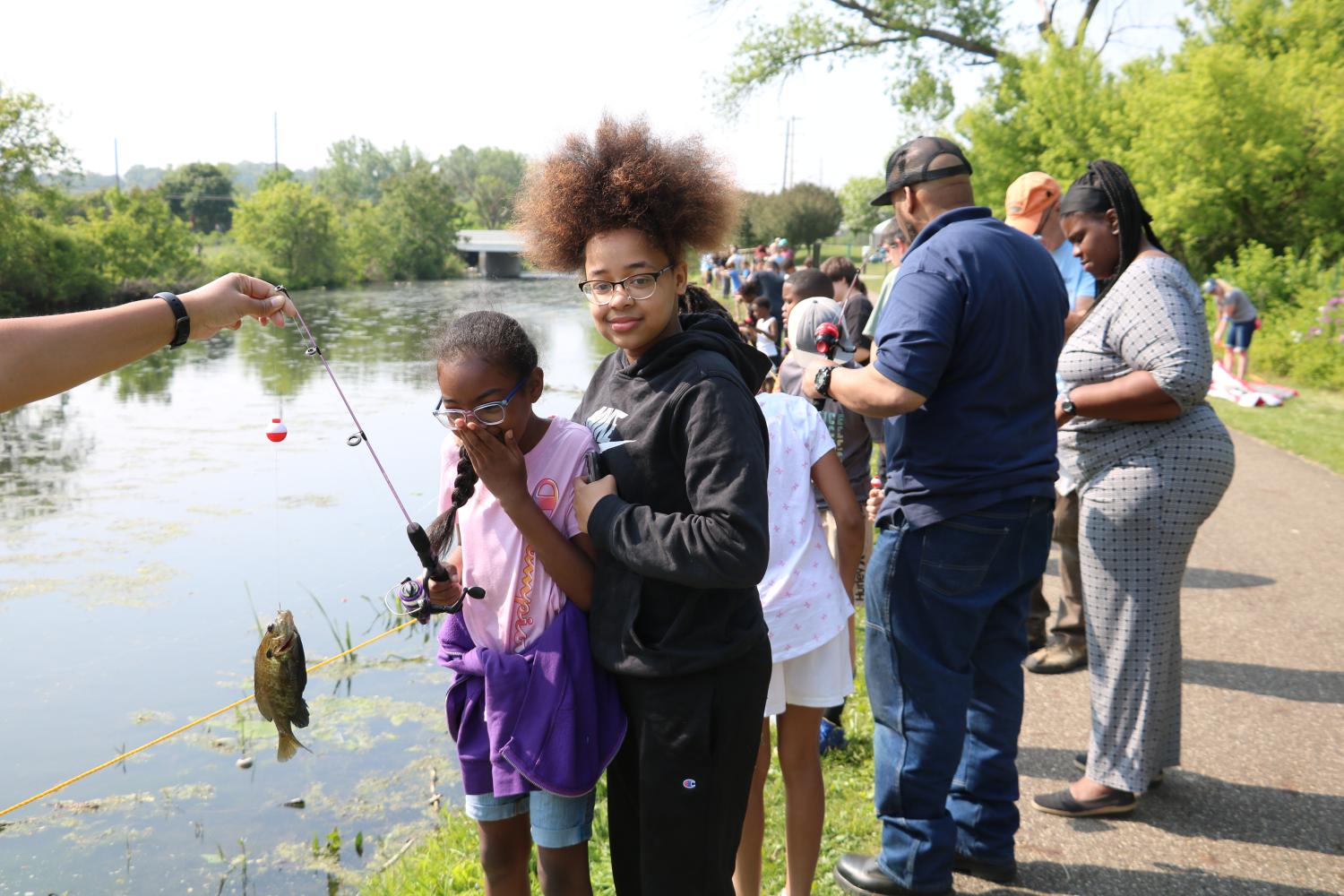 Two students catching fish at the Fishing Derby