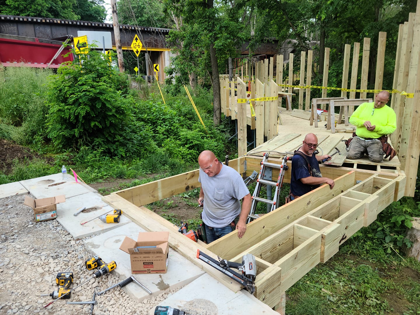 Construction workers building a Towpath Trail boardwalk in Bolivar.