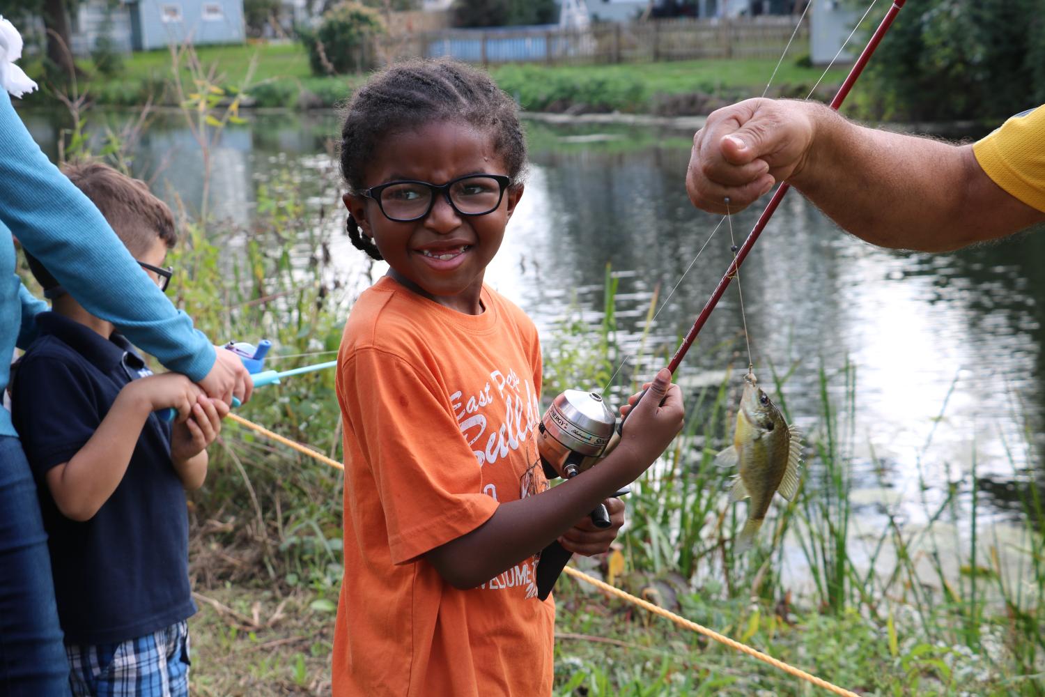 Child with fishing pole.